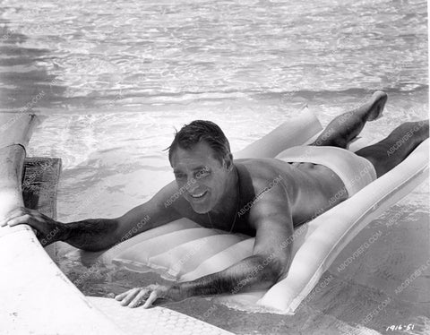 Cary Grant in swim trunks getting some sun in the pool 8b20-14721