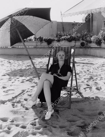 Bette Davis under an umbrella on the beach 8b20-16232