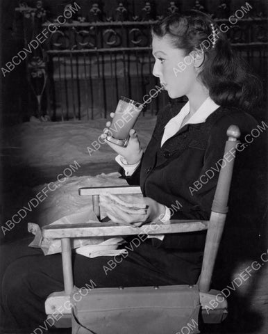 candid Loretta Young enjoys a sandwich and drink behind the scenes 8b20-1677