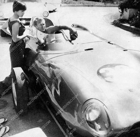 Steve McQueen adjusts the mirrors on his racecar 8b20-19050