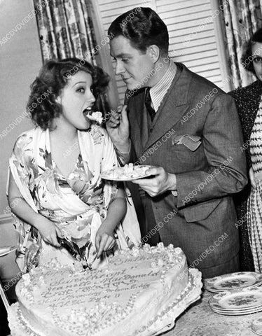 Jeanette MacDonald & Nelson Eddy cutting and eating some cake 8b20-20005