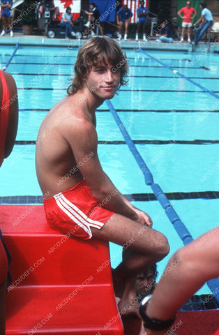 Andy Gibb in swim shorts by the pool 8b20-2072