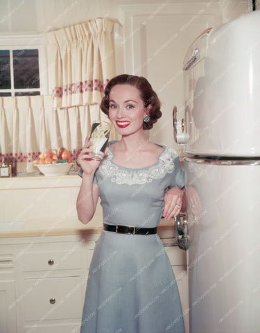 Ann Blythe enjoys a glass of milk in the kitchen 8b20-2306