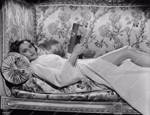 beautiful Barbara Stanwyck lying down reading a book 8b20-3603