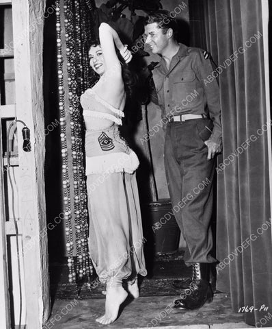 Audie Murphy happily assists with a wardrobe adjustment 8b20-4476