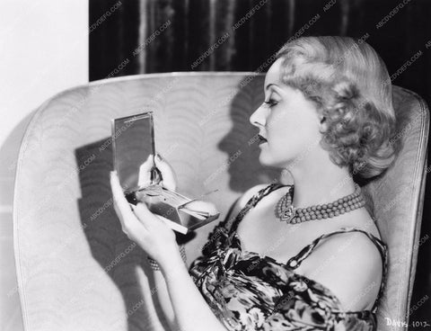 Bette Davis looks in mirror for quick makeup check 8b20-4745