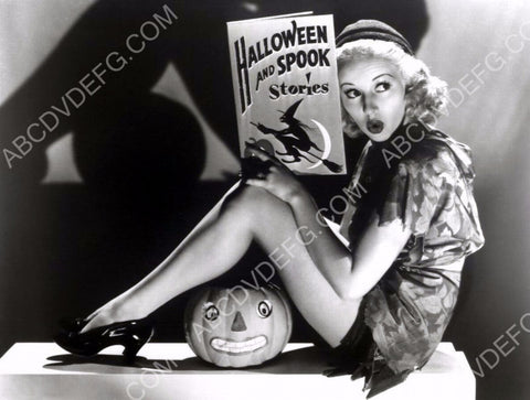 Betty Grable cool Halloween pinup w storybook and jack-o-lantern 8b20-4859