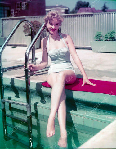 Anne Francis in swimwear dangling her feet in the water 8b20-6674