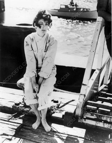 Ava Gardner clothes in tatters sits on pier 8b20-6815