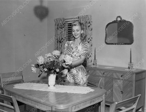 Carole Landis arranges some flowers at home 8b20-6846