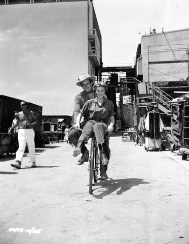 Charlton Heston riding bicycle on studio backlot 8b20-7017