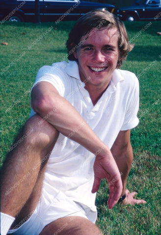 Christopher Atkins sitting in the grass in the park 8b20-7571