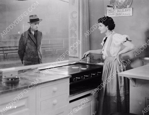Claudette Colbert making pancakes on the griddle 8b20-7783