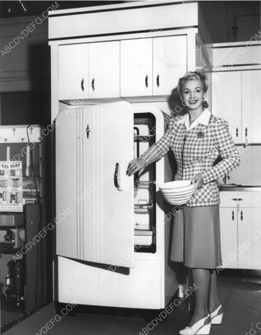 Carole Landis getting something out of the ice box 8b20-7875