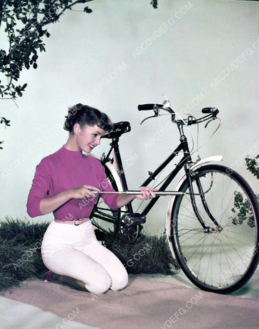 super cute Debbie Reynolds pumps up her bicycle tires 8b20-8144
