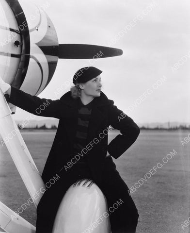 Carole Lombard sitting on an airplane wheel 8b20-9194