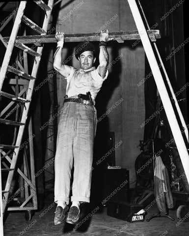 candid Gilbert Roland does a few pull-ups behind the scenes 8b20-9490