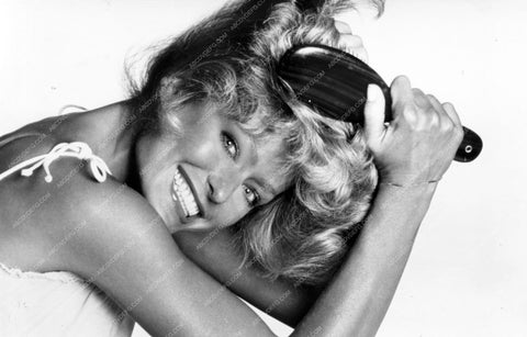 playful Farrah Fawcett brushes her hair 8b20-9552