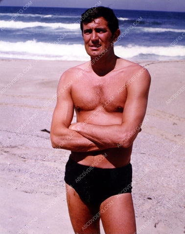 studly George Lazenby in his speedo on the beach 8b20-9670
