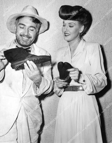crp-10033 1944 J Carrol Naish & Ann Savage examine WWII Tarawa souvenir Japanese sneakers crp-10033