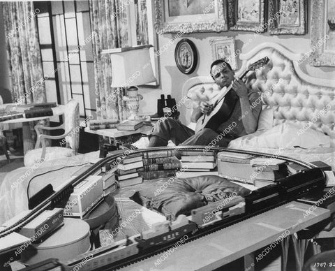 crp-00147 1959 dblwt photo Harry Belafonte relaxes w guitar and model trains film The World the Flesh and the Devil crp-00147
