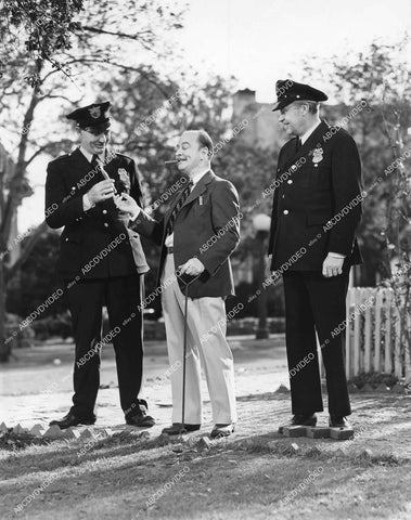 crp-15976 1938 Chester Clute hands out cigars to cops short subject film Life in Sometown U.S.A. crp-15976