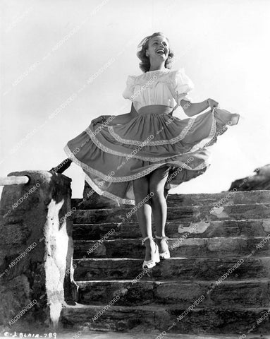 crp-17808 1946 Janet Blair enjoys sunshine and lifts up skirt coming down stairs film Gallant Journey crp-17808