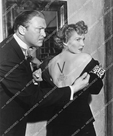 crp-03299 1942 Albert Dekker inspects Paulette Goddard's V for Victory stamped on her back film Lady has Plans crp-03299