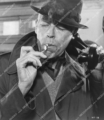 crp-05052 1975 James Coburn lighting a cigarette on the telephone film Hard Times crp-05052