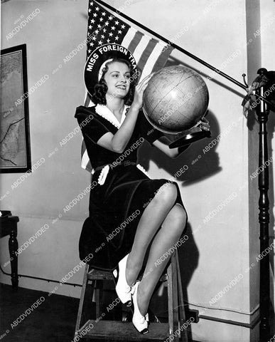 crp-08246 1940 Miss Foreign Trade Jeanne Bishop looks over a globe crp-08246